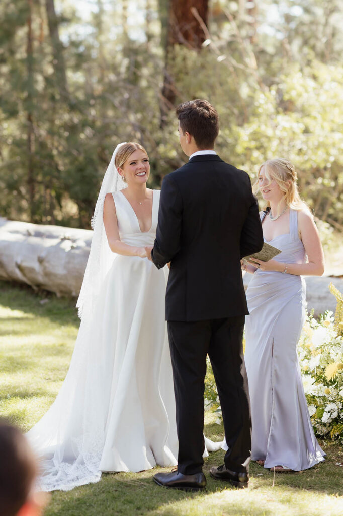 Bride and groom hold hands during their outdoor ceremony at Valhalla Tahoe