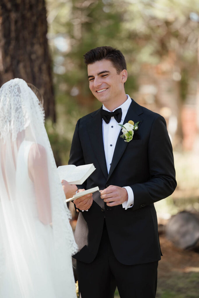 Groom smiles as the bride reads her vows during their Valhalla Tahoe ceremony