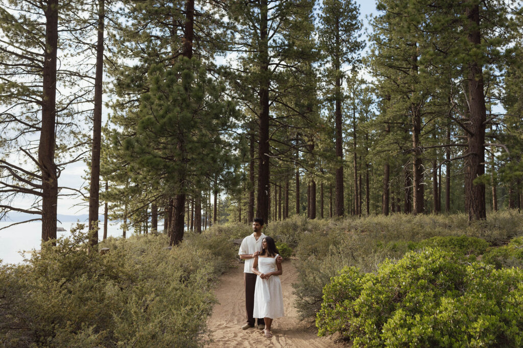 Couple hugging on a peaceful pine forest trail during their South Lake Tahoe engagement session