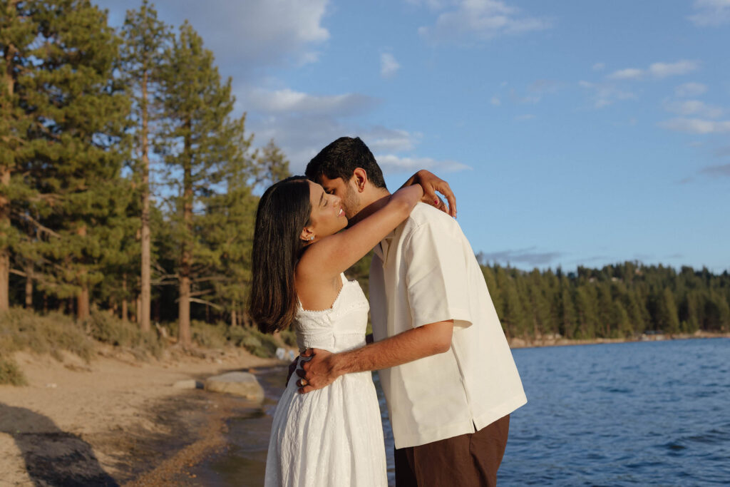 Engaged couple sharing an intimate embrace on the beach during their South Lake Tahoe engagements