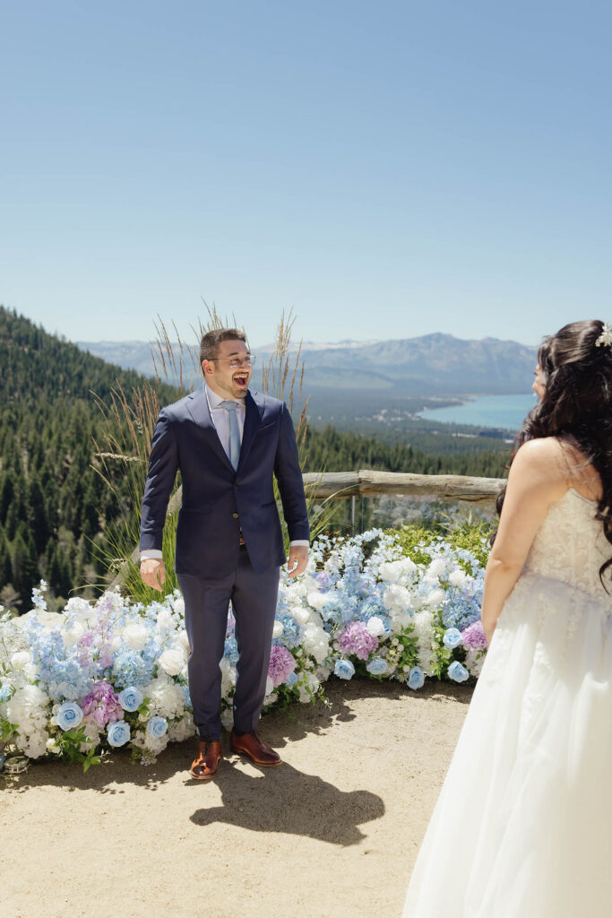 Groom reacting to seeing his bride during their first look at Tahoe Blue Estate overlooking Lake Tahoe