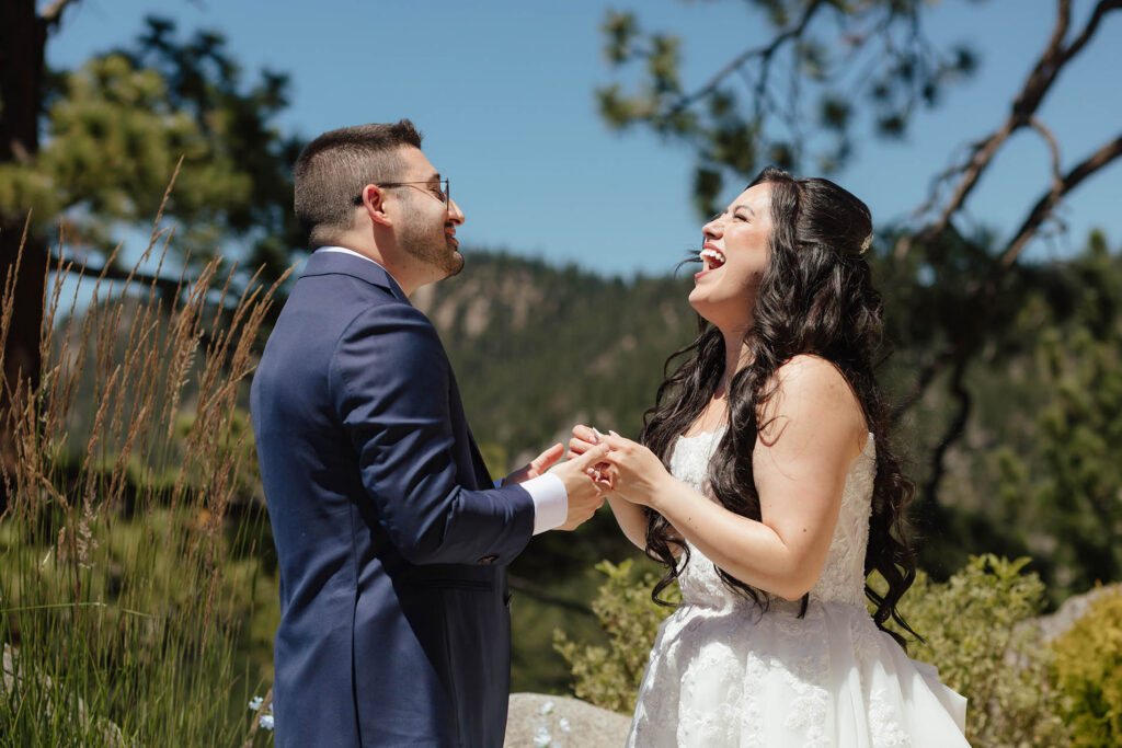 Bride and groom laughing together during their first look at Tahoe Blue Estate