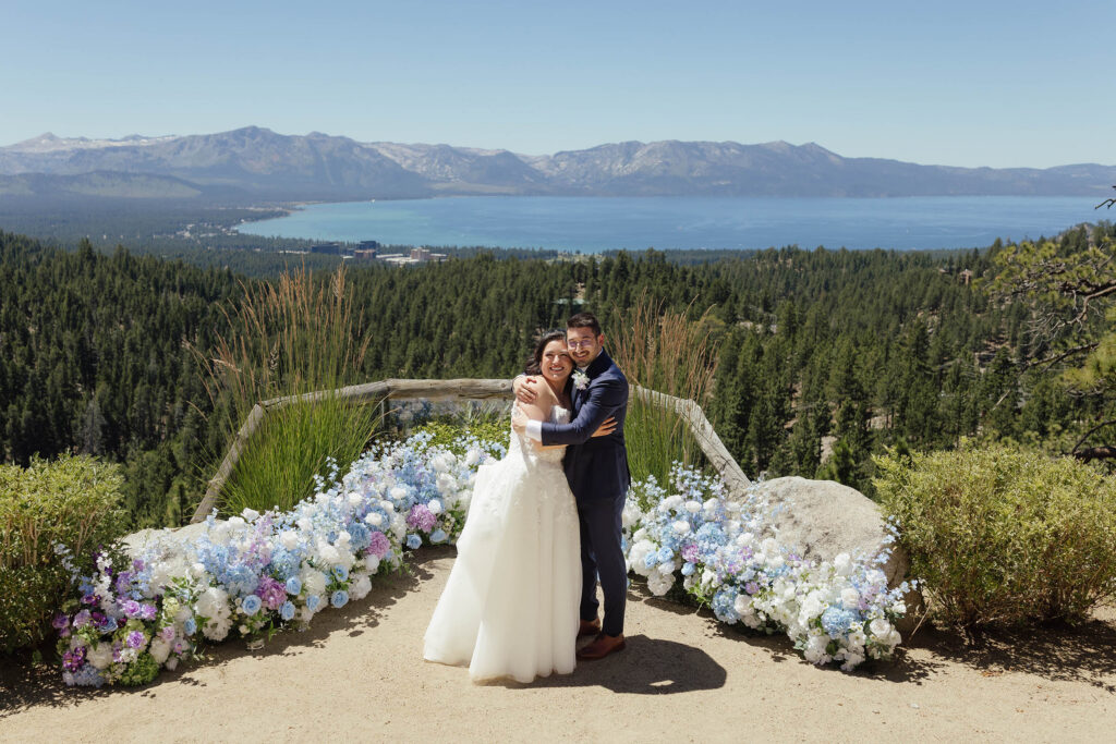 Bride and groom hugging at their Tahoe Blue Estate wedding overlooking the lake and mountains