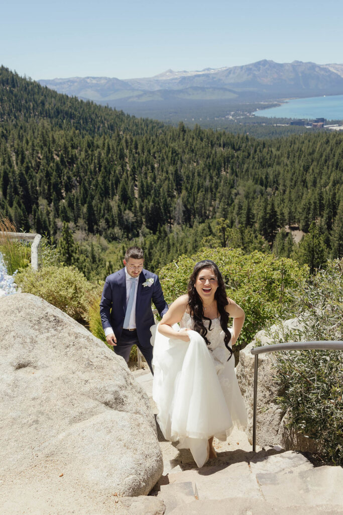 Bride laughing as she and the groom climb stone steps at Tahoe Blue Estate