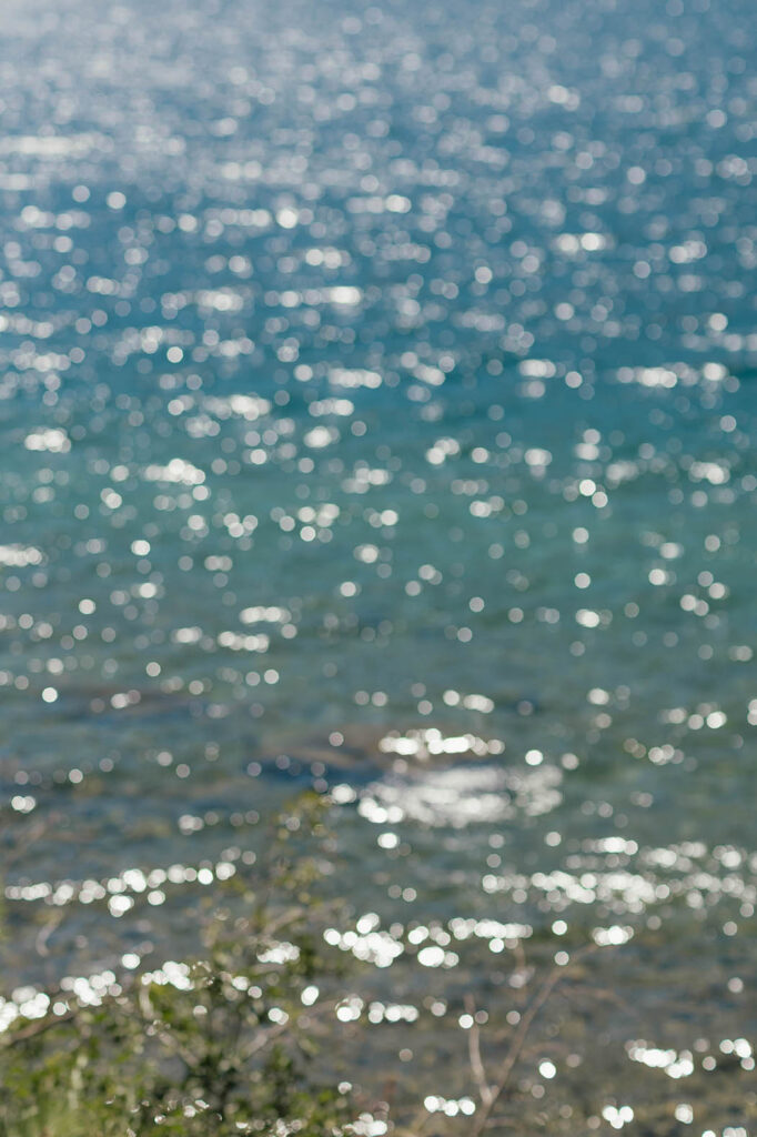 Summer sunlight sparkling across the clear blue water of Lake Tahoe