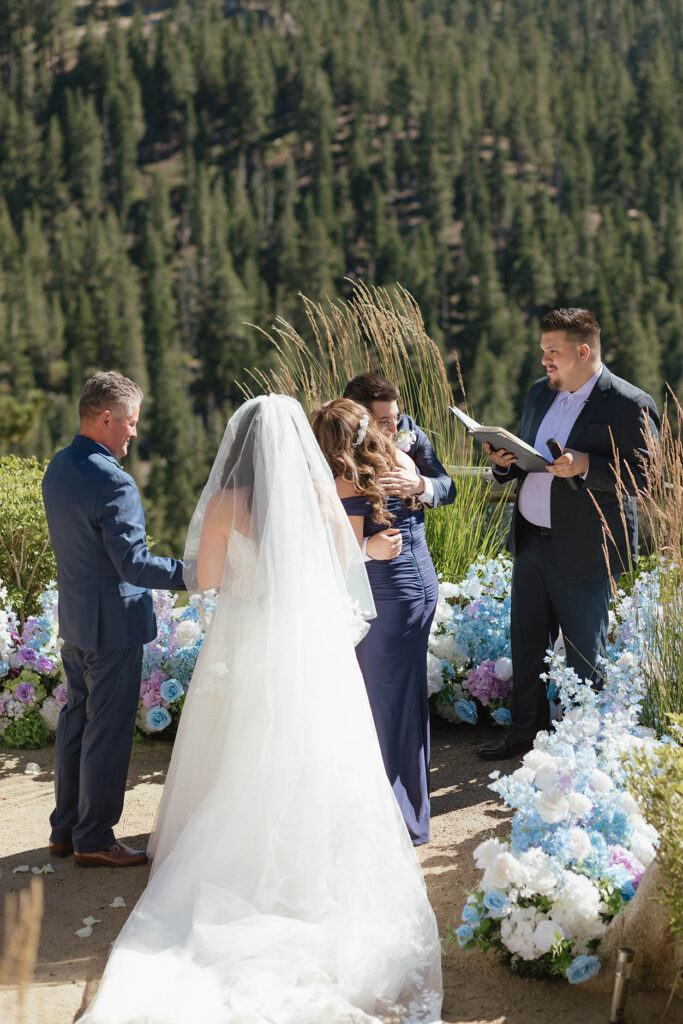 Groom hugging a family member during the outdoor Tahoe Blue Estate wedding ceremony