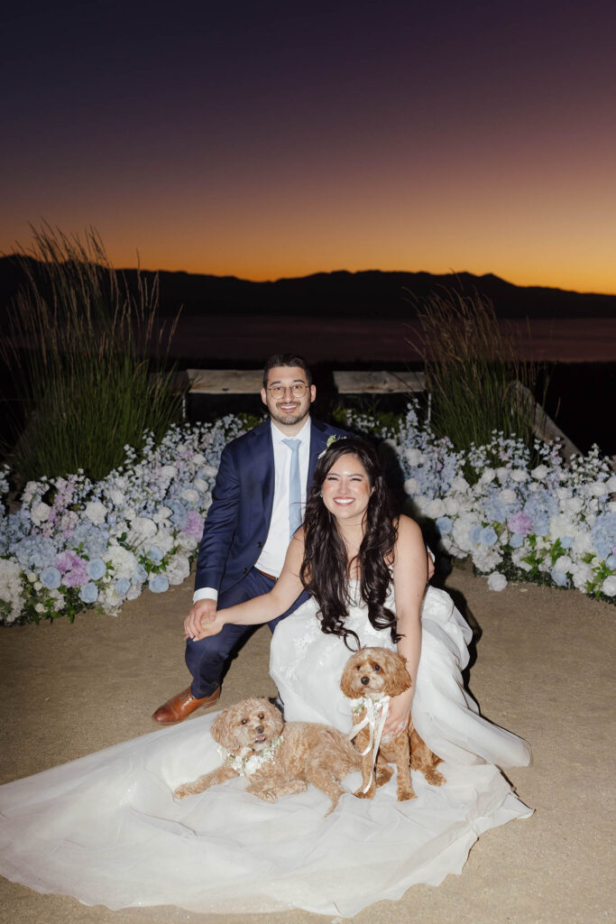 Bride and groom posing with their two dogs after their Tahoe Blue Estate wedding
