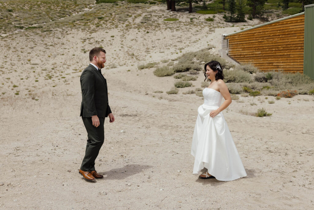 Bride and groom smiling during their first look at Mt Rose before their Winters Creek Lodge wedding